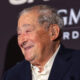 Bob Arum smiling at a press conference