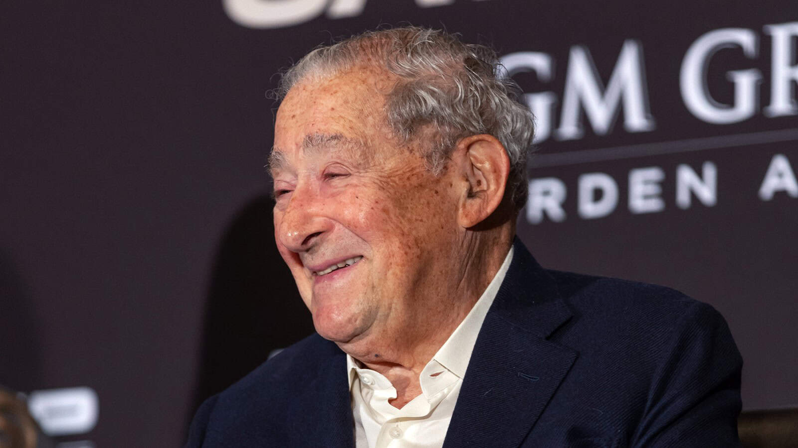 Bob Arum smiling at a press conference