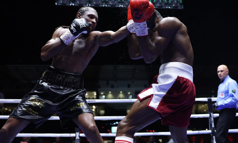 Craig Richards lands a punch on Dan Azeez during their light heavyweight bout at Legon Sports Stadium in Accra, Ghana.