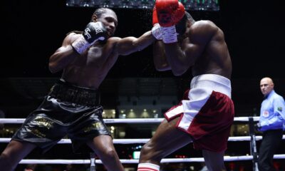 Craig Richards lands a punch on Dan Azeez during their light heavyweight bout at Legon Sports Stadium in Accra, Ghana.