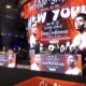 Wide shot of the press conference stage for Teofimo Lopez vs Shakur Stevenson with promotional graphics on screen.