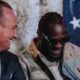 Deontay Wilder laughs with Kalle Sauerland during a press conference ahead of his fight with Derek Chisora