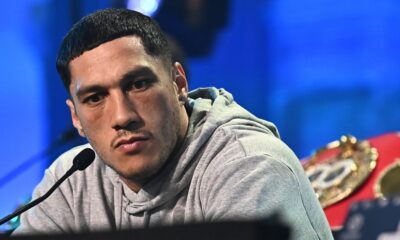 Jai Opetaia speaks at a press conference with the IBF cruiserweight title belt behind him