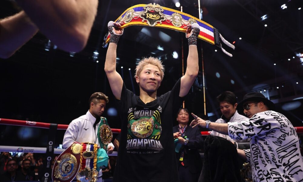 Naoya Inoue raises his championship belt overhead inside the ring after defeating Alan Picasso at the Mohammed Abdo Arena in Riyadh, Saudi Arabia.