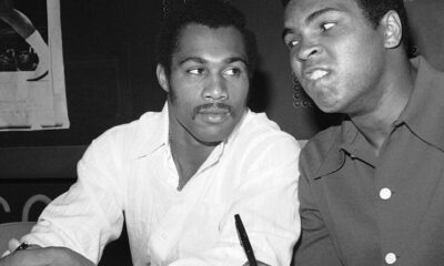Muhammad Ali and Ken Norton seated together at a press event in 1973