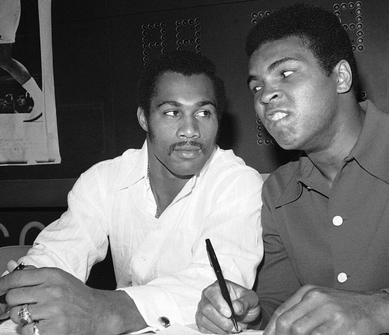 Muhammad Ali and Ken Norton seated together at a press event in 1973