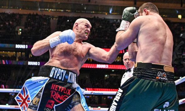 Tyson Fury lands a punch on Arslanbek Makhmudov during their heavyweight fight at Tottenham Hotspur Stadium