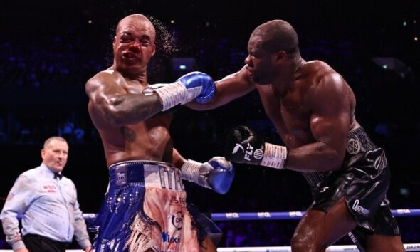 Fabio Wardley takes a heavy right hand from Daniel Dubois during their WBO heavyweight title fight in Manchester as Dubois stages a comeback victory.