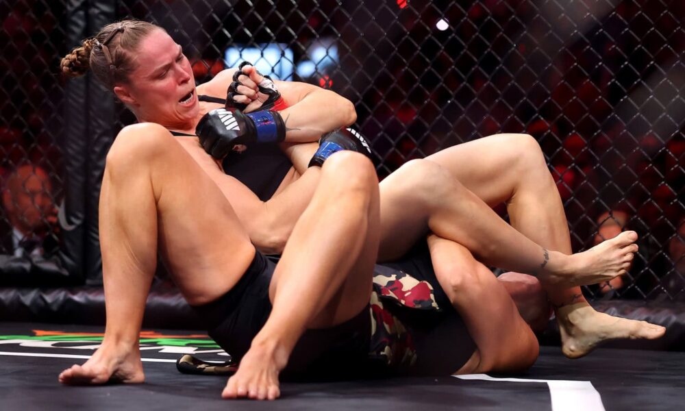 Ronda Rousey locks in an armbar submission against Gina Carano during MVP MMA’s debut Netflix event.