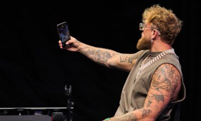 Jake Paul films himself on a phone during a public appearance amid fresh Canelo Alvarez fight speculation.