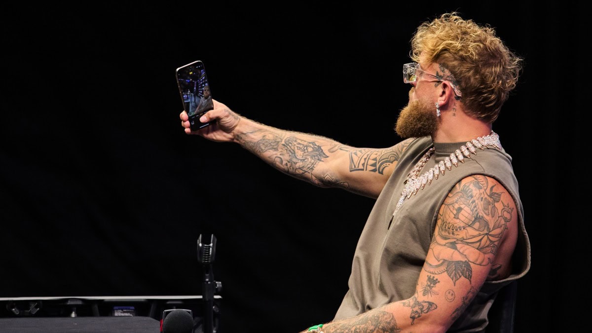 Jake Paul films himself on a phone during a public appearance amid fresh Canelo Alvarez fight speculation.