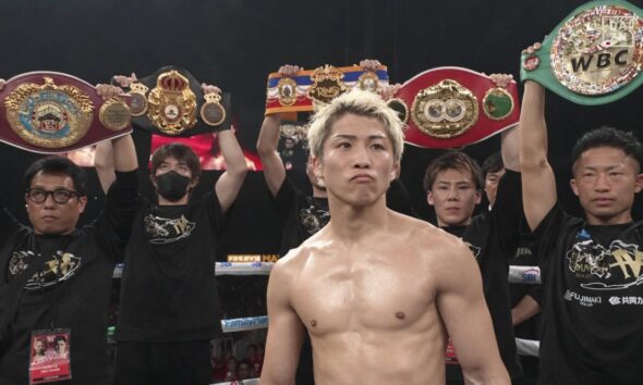 Naoya Inoue poses with world title belts at Tokyo Dome before facing Junto Nakatani
