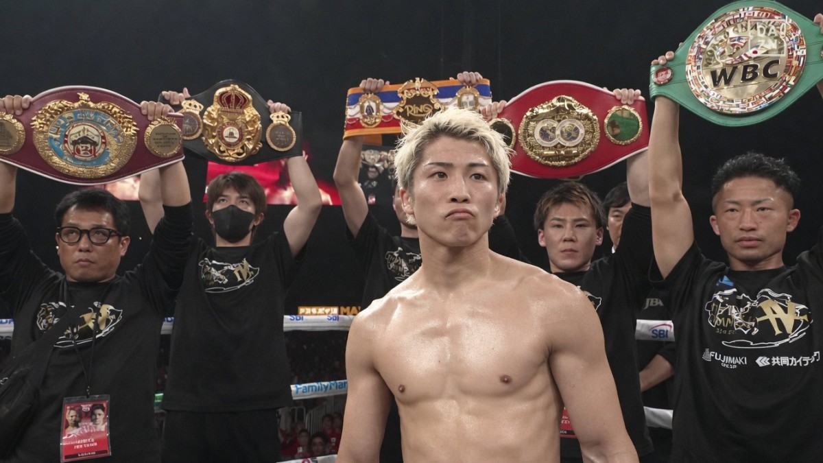 Naoya Inoue poses with world title belts at Tokyo Dome before facing Junto Nakatani