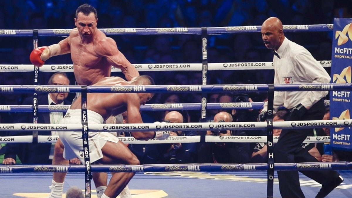 Wladimir Klitschko stands over Anthony Joshua after knocking him down during their heavyweight title fight at Wembley Stadium in 2017