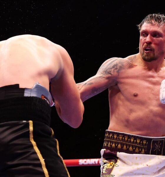 Oleksandr Usyk lands a punch on Rico Verhoeven during their heavyweight title fight beneath the Giza Pyramids in Egypt.