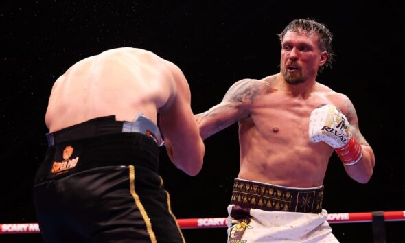 Oleksandr Usyk lands a punch on Rico Verhoeven during their heavyweight title fight beneath the Giza Pyramids in Egypt.
