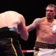 Oleksandr Usyk lands a punch on Rico Verhoeven during their heavyweight title fight beneath the Giza Pyramids in Egypt.