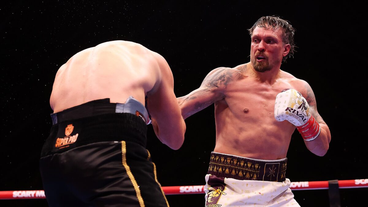 Oleksandr Usyk lands a punch on Rico Verhoeven during their heavyweight title fight beneath the Giza Pyramids in Egypt.