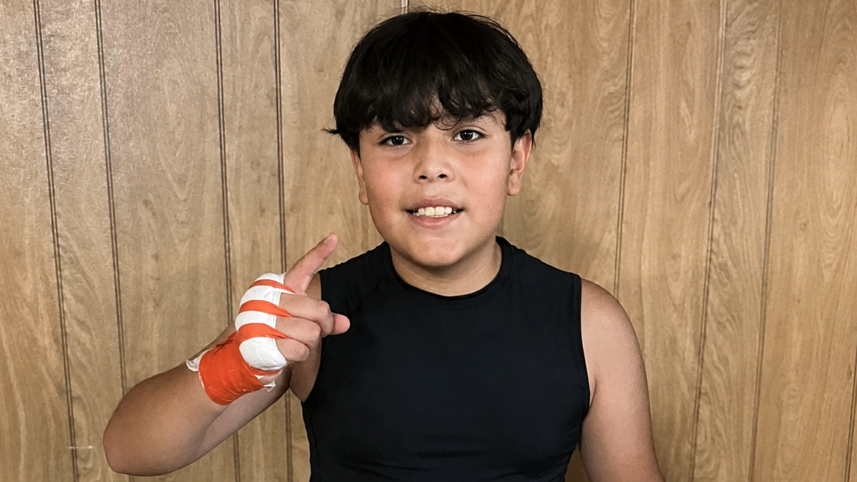Anderson Aguilar poses in boxing training gear during his early journey in the sport