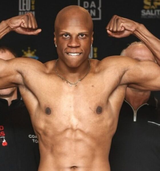 Atif Oberlton flexes during an official weigh-in with Dmitriy Salita standing behind him.