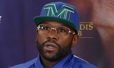 Floyd Mayweather wearing a TMT cap and glasses during a media event