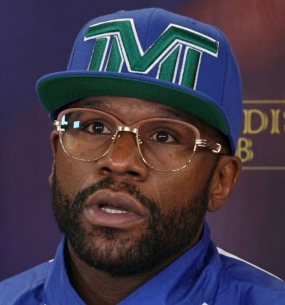 Floyd Mayweather wearing a TMT cap and glasses during a media event