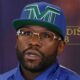 Floyd Mayweather wearing a TMT cap and glasses during a media event