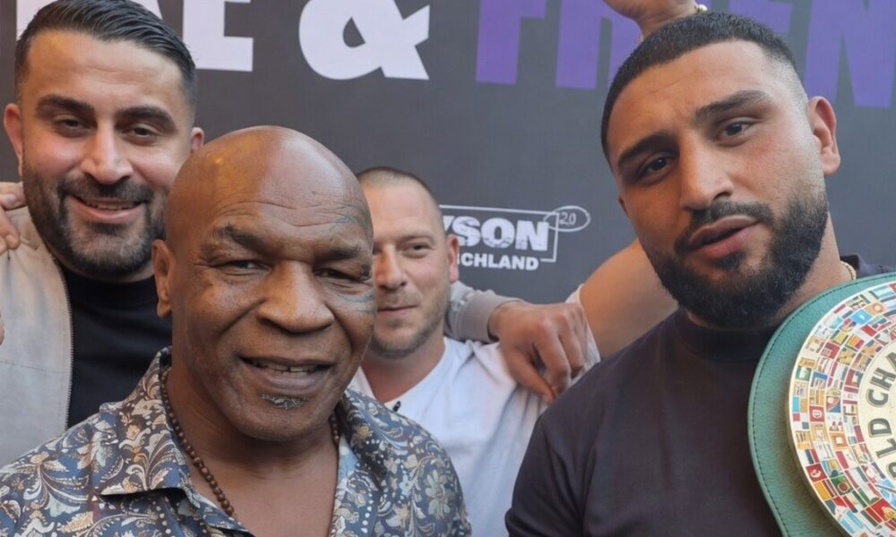 Mike Tyson poses with WBC mandatory heavyweight challenger Agit Kabayel as the German contender displays a championship belt during a public appearance in Germany