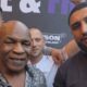 Mike Tyson poses with WBC mandatory heavyweight challenger Agit Kabayel as the German contender displays a championship belt during a public appearance in Germany