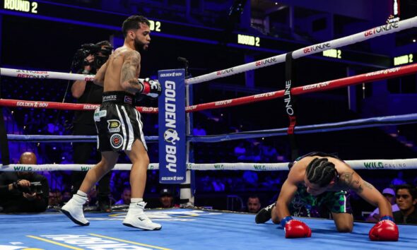Oscar Collazo stands over Neider Valdez after scoring a knockdown during their flyweight bout in Oceanside, California