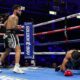 Oscar Collazo stands over Neider Valdez after scoring a knockdown during their flyweight bout in Oceanside, California