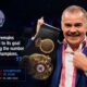 Gilberto Mendoza holding a WBA title belt inside a boxing ring during a championship presentation