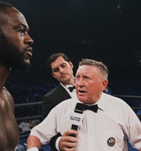 Deontay Wilder and Evgeny Romanov face off in the ring before their amateur bout, with a referee standing between the two fighters during the pre-fight instructions